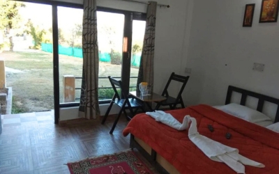 Comfortable room interior with glass doors opening to a grassy lawn.