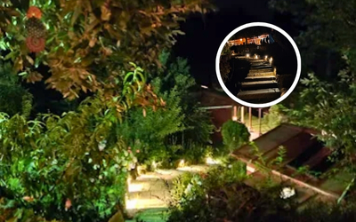 Illuminated stone steps winding up the hillside at night